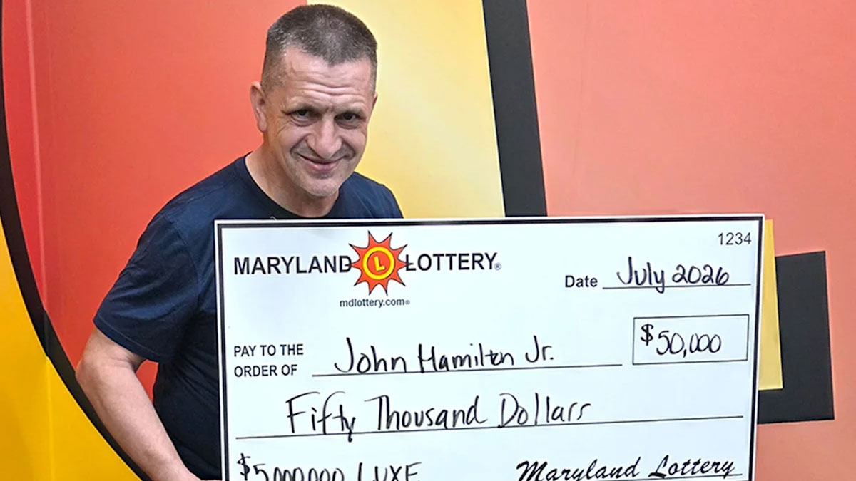 A man hold a giant check.