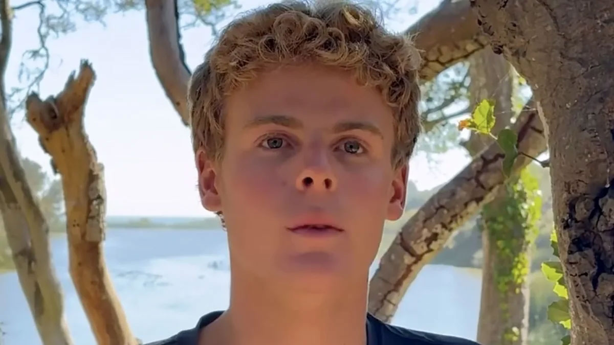 A young man looks off camera.