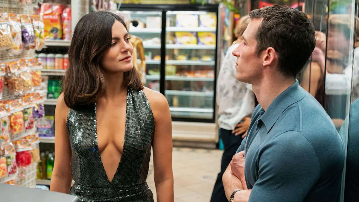A woman and a man look at each other.